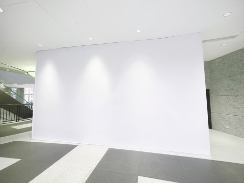 Blank white wall inside a large modern building