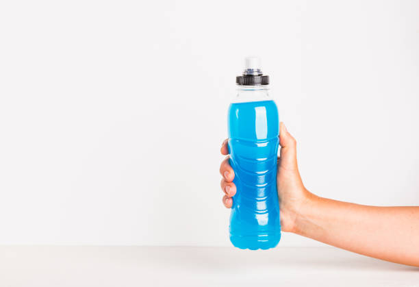 istock Isotonic energy drink copy space white background. Woman hand holding bottle with hydration sport beverage. 1772391526