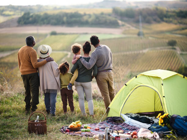istock Back view of black extended family during camping on a hill. 1772391531