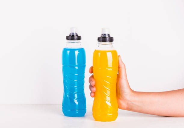 istock Isotonic drink in bottle, energy mineral hydration balance beverage copy space background. Woman hand holding sport mineral vitamin drink bottle. 1772392074