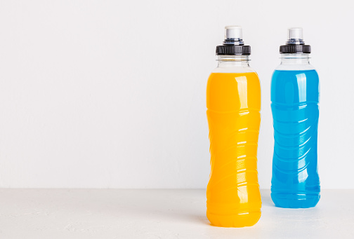 Sport isotonic drink in bottle, energy mineral hydration balance beverage copy space.