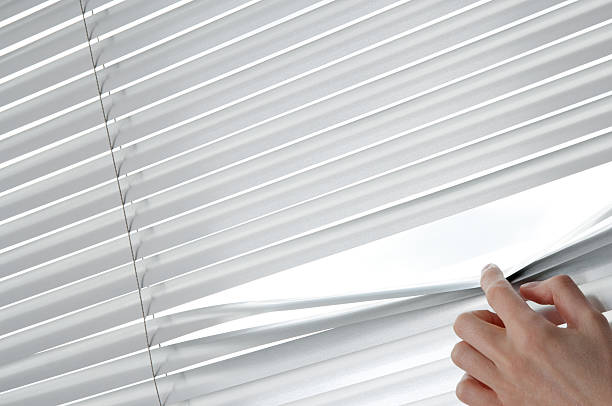 istock Female hand opening venetian blinds with a finger 177239602