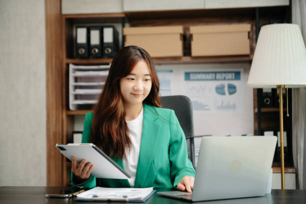 istock Young beautiful woman using laptop and tablet while sitting at her working place. Concentrated at work. 1772402184