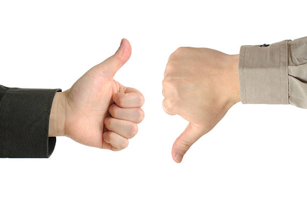 One hand with a thumbs up and one with a thumbs down stock photo
