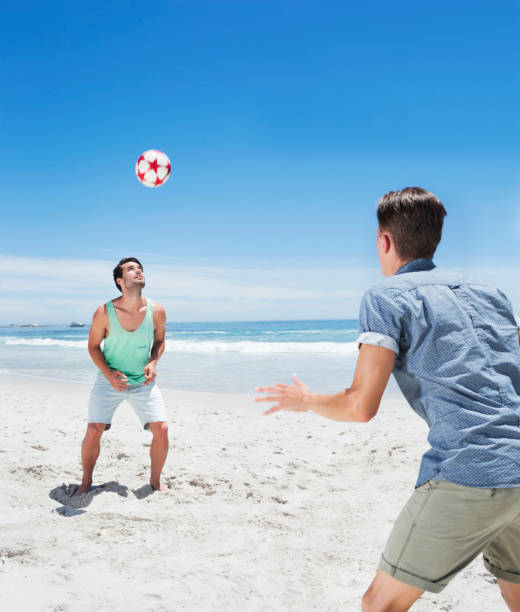 istock Man heading soccer ball on beach 177240915