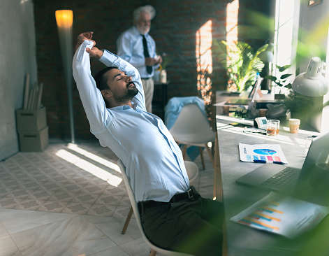 calm businessman taking break to relax in office