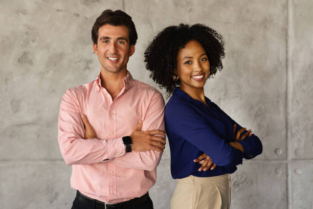 istock Two successful multicultural businesspeople standing back to back, arms crossed 1772413201