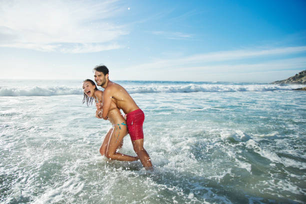 istock Enthusiastic couple hugging and splashing in ocean 177241399
