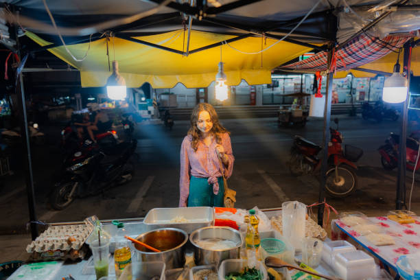 istock Woman ordering on night market in Thailand 1772414257