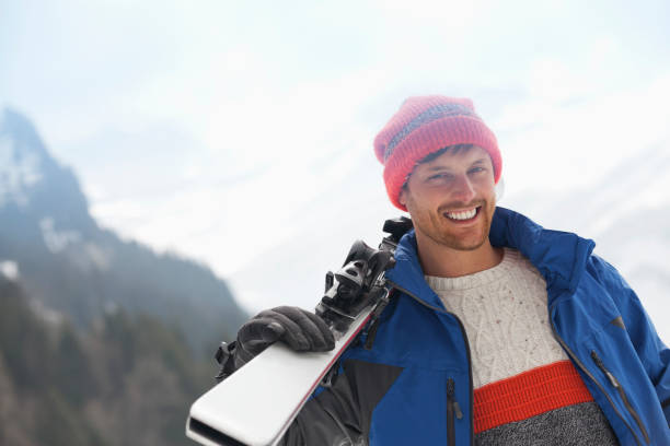 istock Portrait of smiling man holding skis 177241634