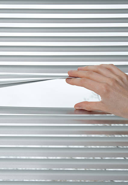 Hand opening venetian blinds for peeking