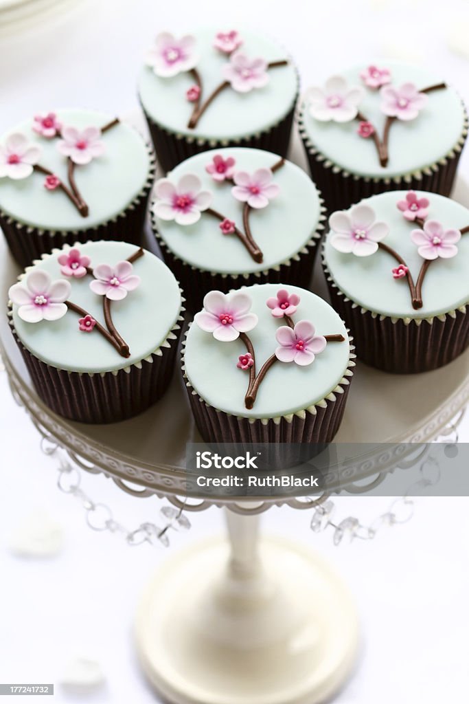 Cherry blossom cupcakes Cupcakes decorated with sugar cherry blossomsPlease see my portfolio for lots more cupcakes - Baked Stock Photo