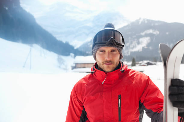 istock Portrait of confident man with skis in snowy field 177242528
