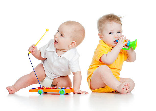 istock Funny babies  with musical toys on white background 177242574