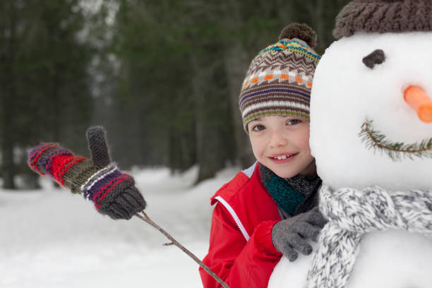 istock Close up of smiling boy behind snowman 177242937