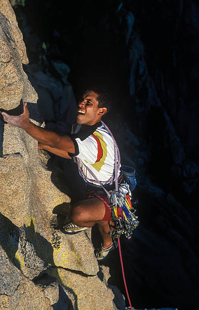 An action image of a rock climber struggling stock photo