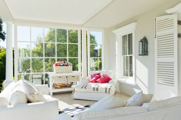 Cozy screened porch winter during Holidays season, snowy roofs and woods in the background.