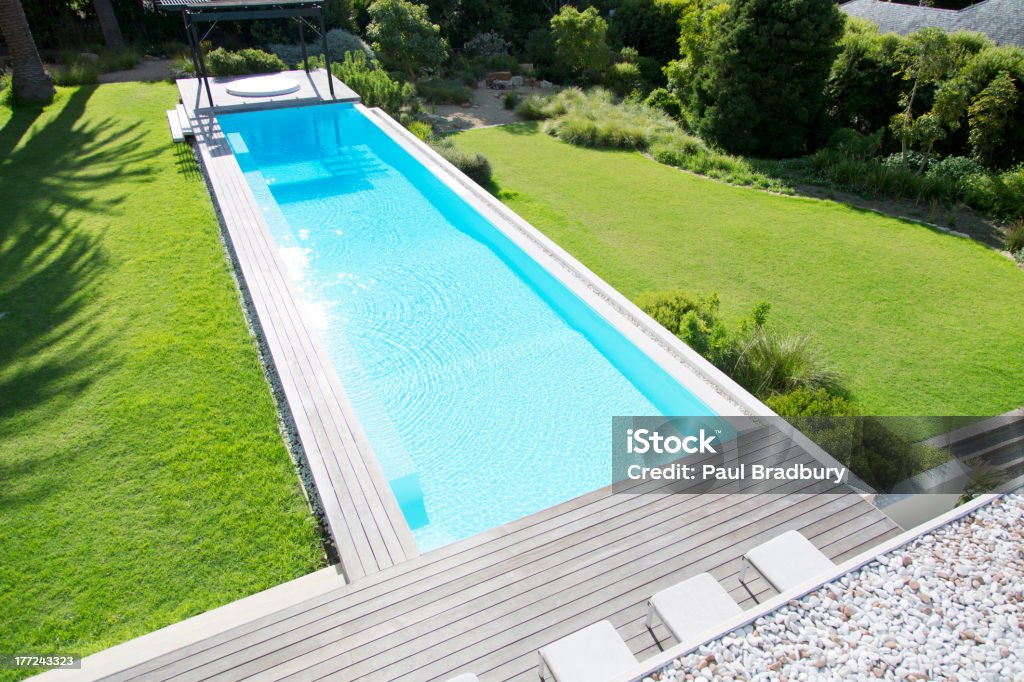 Sun shining on luxury lap pool  Lap Pool Stock Photo