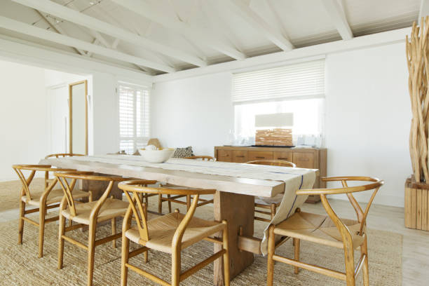 Bright room with round dining table and wicker chairs