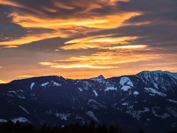 istock Beautiful dramatic orange golden sunset over a snowy winter mountain ridge 1772435879