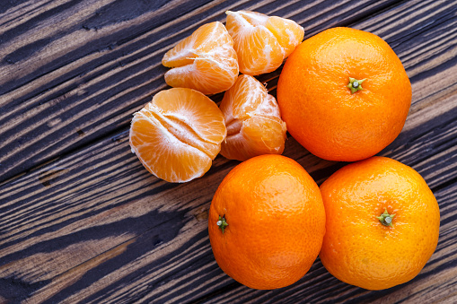 Mandarine orange or tangerine on wooden board