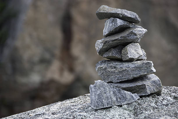 inukshuk "Inukshuk in Kenora Ontario, used as a directional marking or a symbol of a persons presence in a place." kenora stock pictures, royalty-free photos & images