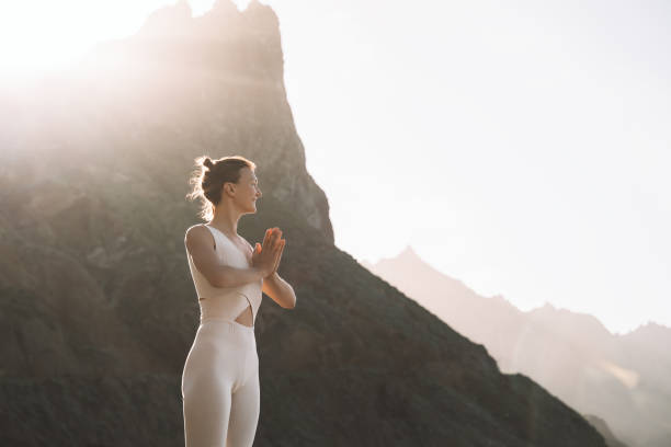 istock Woman is practicing yoga, meditating on the beach. 1772444408