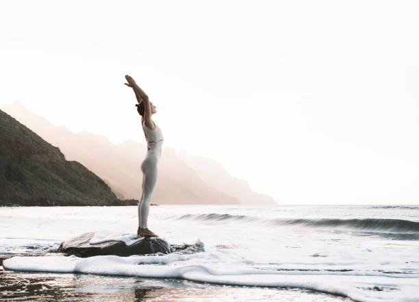 istock Woman is practicing yoga on the beach. 1772444946