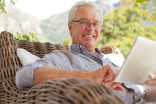 istock Portrait of smiling man using digital tablet on patio 177244595