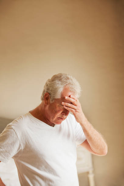 istock Senior man holding head in pain 177244709