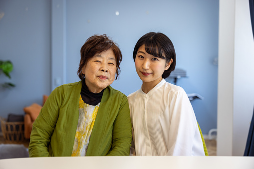 Family portrait of grandmother and granddaughter at home