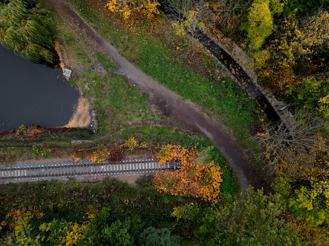 fly over railroad tracks in the countryside. vertical view of the landscape. background, texture modelers, theme transport journalists. background from above. even the dam of the pond is a dead end