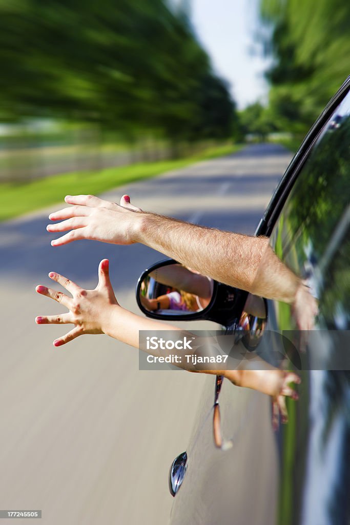 Two arms sticking out of the car Two arms sticking out of the car, family road trip Family Stock Photo