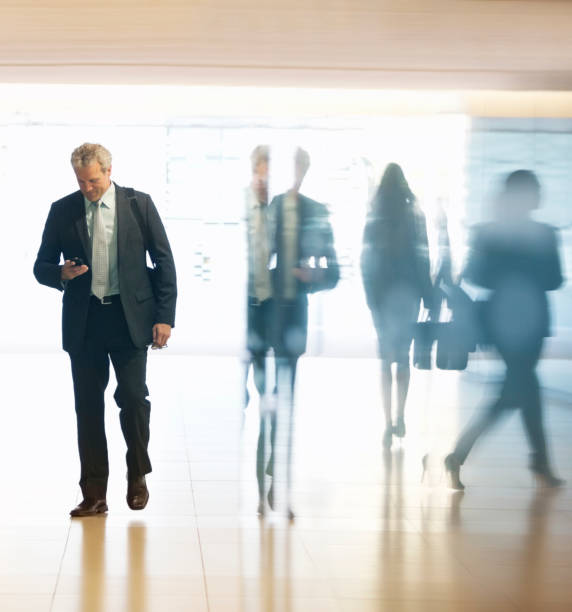 istock Businessman checking cell phone in lobby 177245936