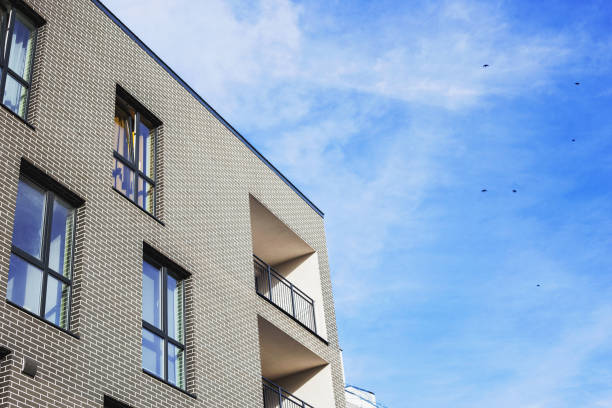 Urbanism, modern construction solutions, asymmetry of windows. Urbanism, modern construction solutions, asymmetry of windows. Investments in real estate. Building, low floor, cozy residential complex in a residential area of the city, place for text, copyspace new urbanism stock pictures, royalty-free photos & images