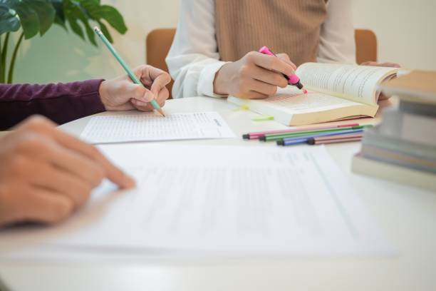 istock Learning with friends Young students campusHigh School Tutor for examining helps school homework together withÂ friend catching up and learning 1772478378