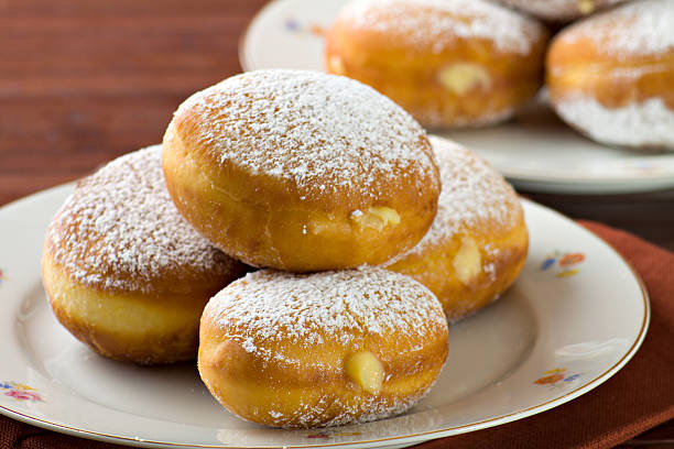 Sweet krapfen (bomboloni) pastry Sweet komemade krapfen pastry so called bomboloni, in Italy, (food -dessert) fullfilled wit a delicious cream. custard stock pictures, royalty-free photos & images