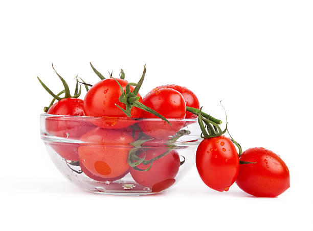 istock fresh tomatoes with green leaf in plate isolated 177248310
