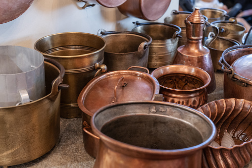 Copper Pots and Pans and other Kitchen Utensils in an Antique Kitchen.