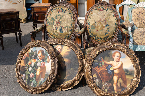 Antique Wooden Stuffed - Chairs and Antique Paintings Leaning Outside on the Street.