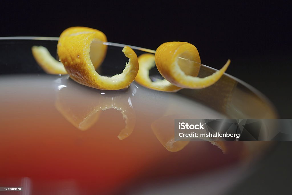 Sea of Cortez Martini Closeup of a pink-colored, Sea of Cortez martini with an orange garnish; shallow depth of field, on black background Alcohol - Drink Stock Photo