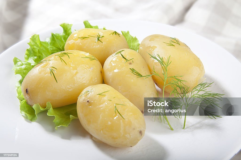 Boiled potato Boiled potato with lettuce and dill on the plate Boiled Stock Photo