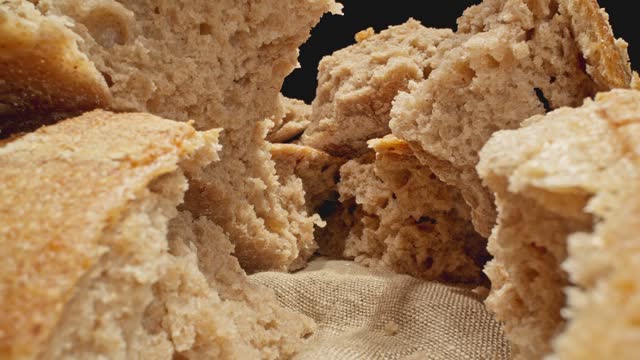 Pile of bread pieces. Camera moving through row of fresh breads. Macro