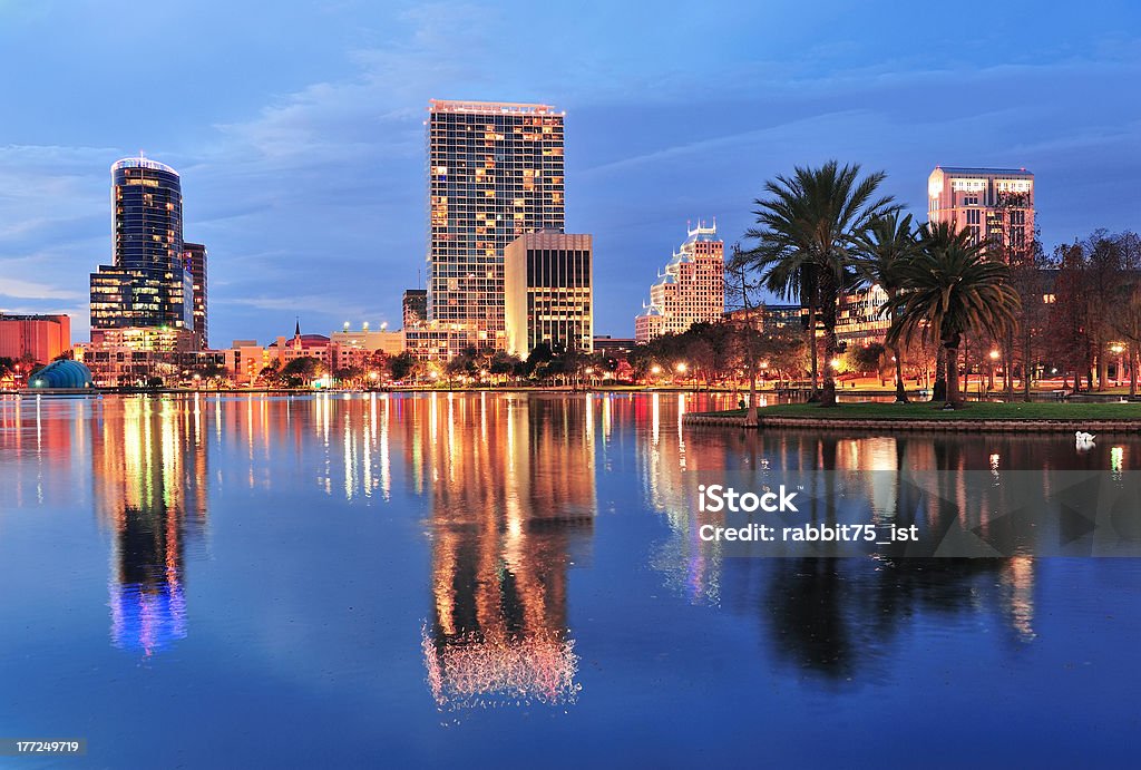 Orlando downtown dusk Orlando downtown skyline over Lake Eola at dusk with urban skyscrapers and lights. Architecture Stock Photo