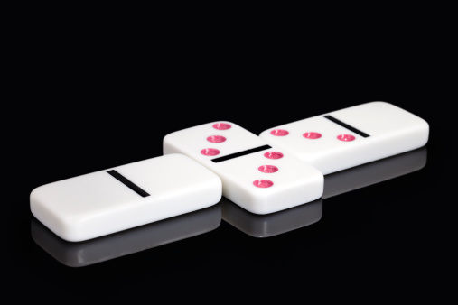 Three Domino pieces with matching end blank peices symbolising only one way to play. Clipping path has been included of the dominoes.