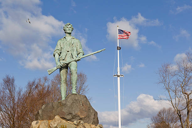 Minuteman Statue and US Flag stock photo