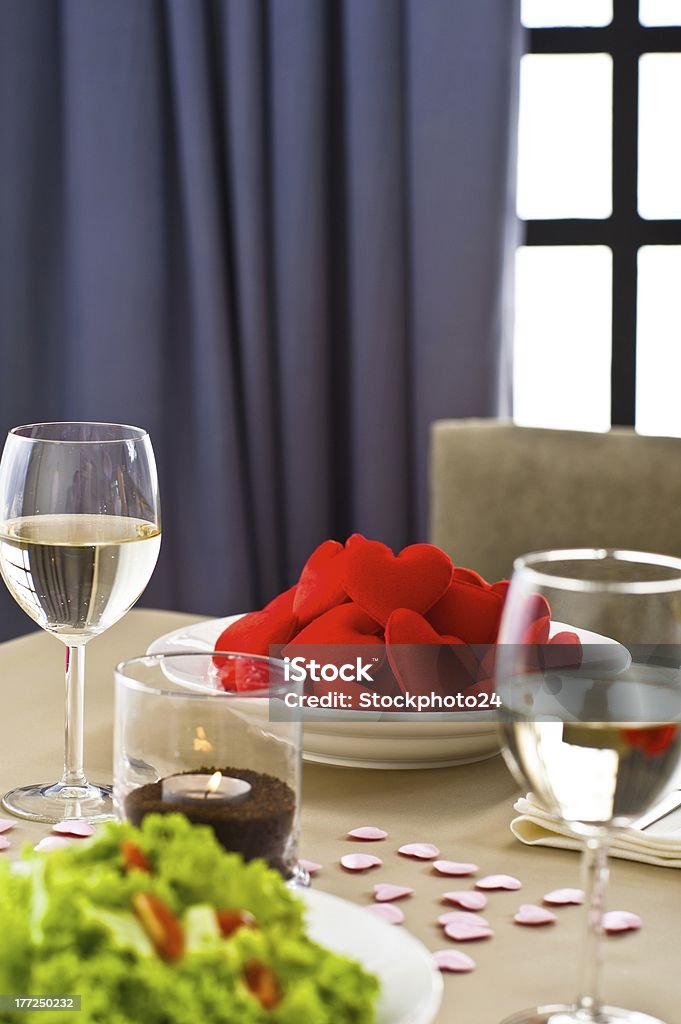 Inside interior table setting with beautiful salad Inside interior table setting with beautiful salad and one plate of hearts Alcohol - Drink Stock Photo