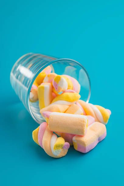 istock Sweet colorful marshmallows on blue background. 1772504828
