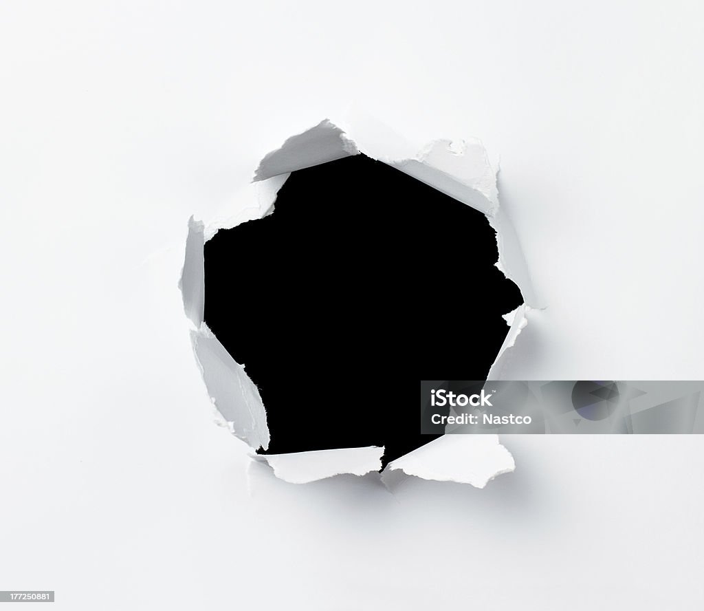 Hole Hole in the paper sheet over black background Paper Stock Photo