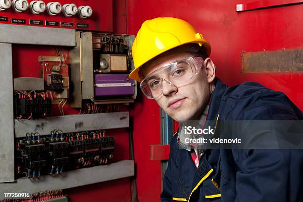 Patch Panel Inspector In Hard Hat Facing Camera By Machinery Stock Photo - Download Image Now